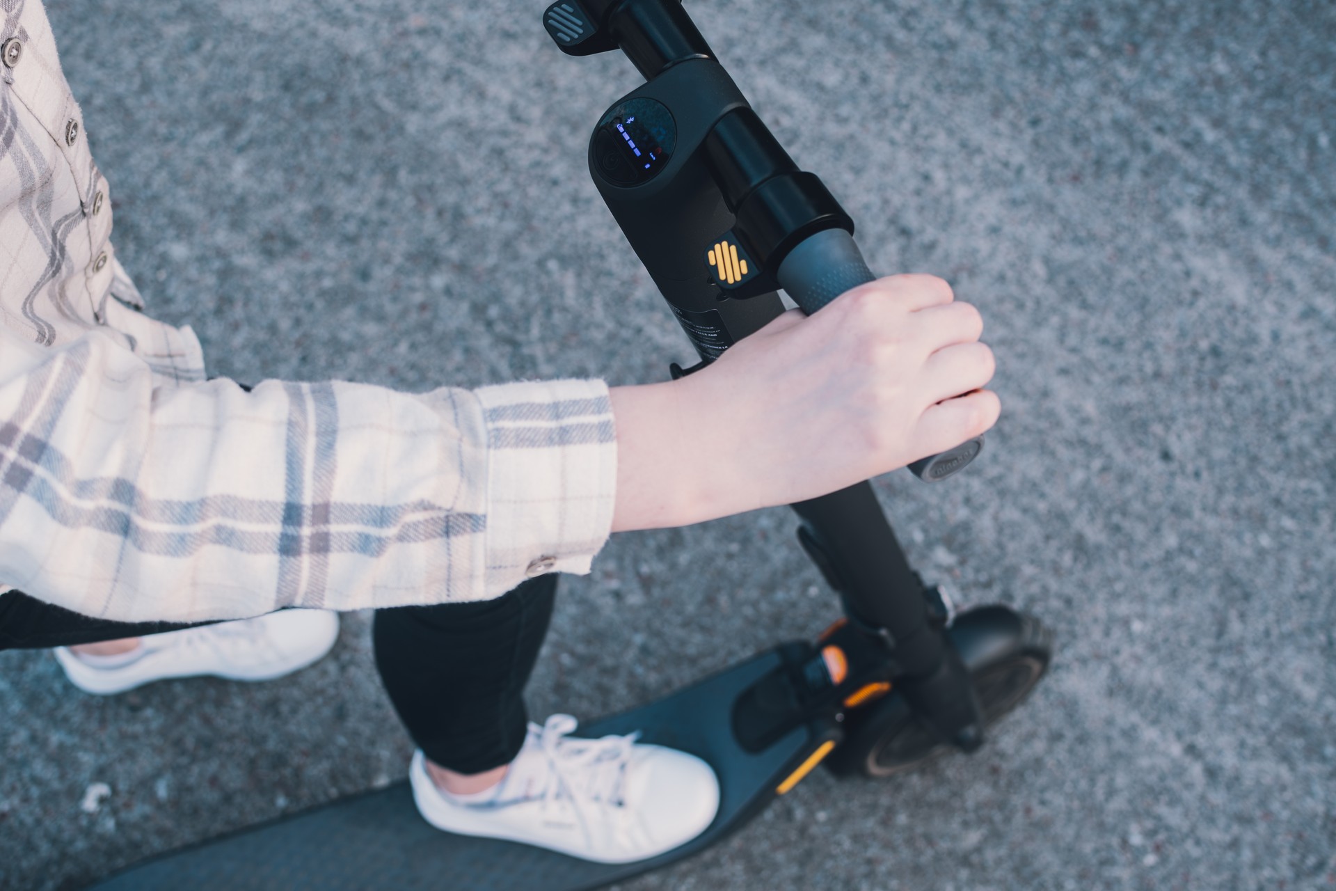 Girl standing on an electric scooter